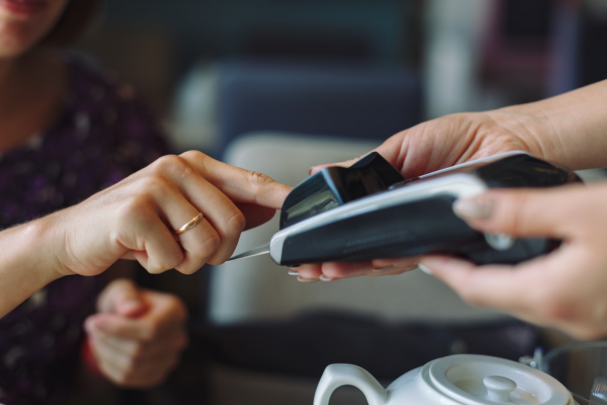 Woman paying his bill in restaurant