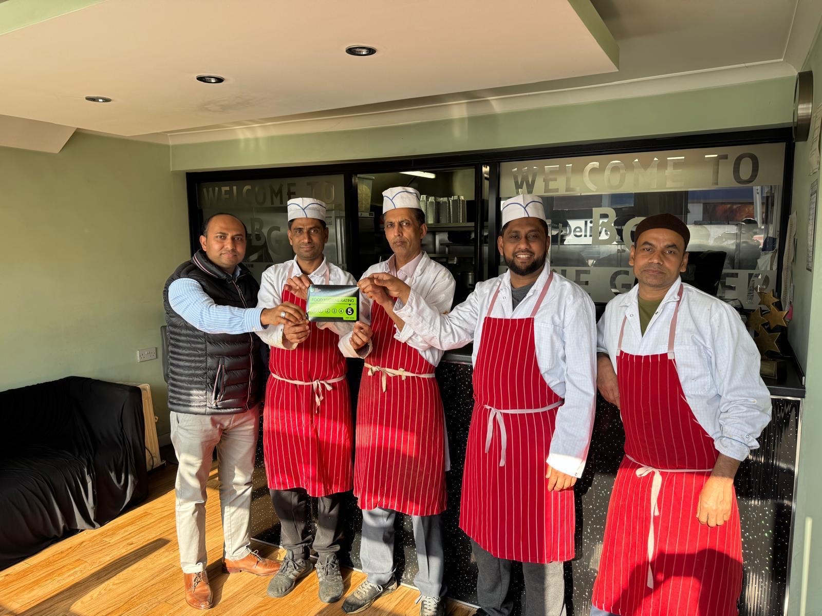 Another person holding hygiene rating card